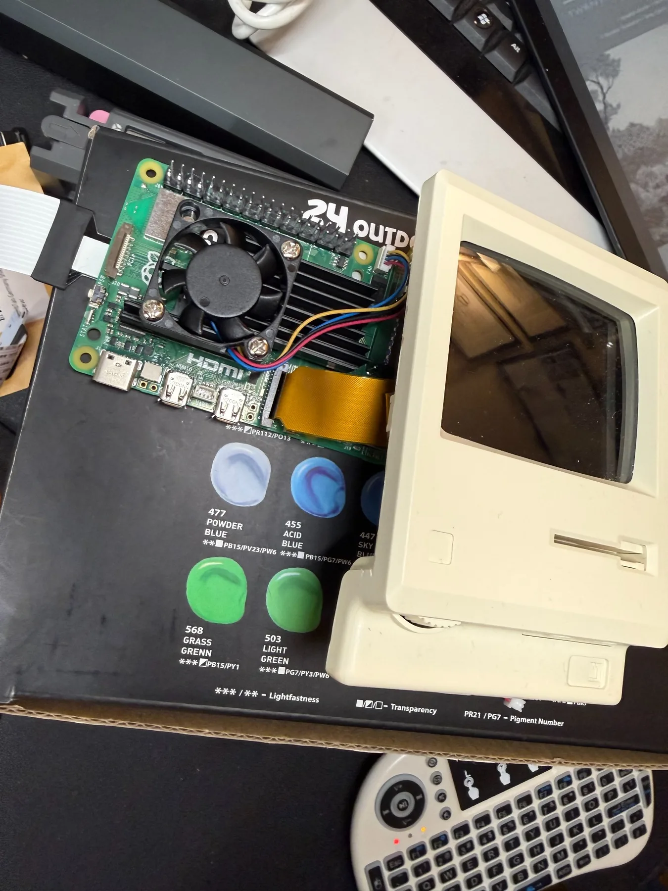 Raspberry Pi 5 board and miniature Macintosh shell during the build