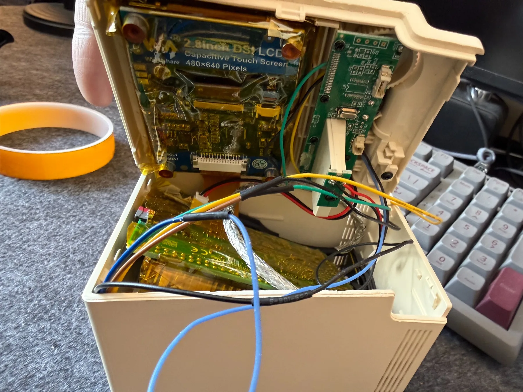 Custom wiring and display hardware inside the miniature Macintosh computer