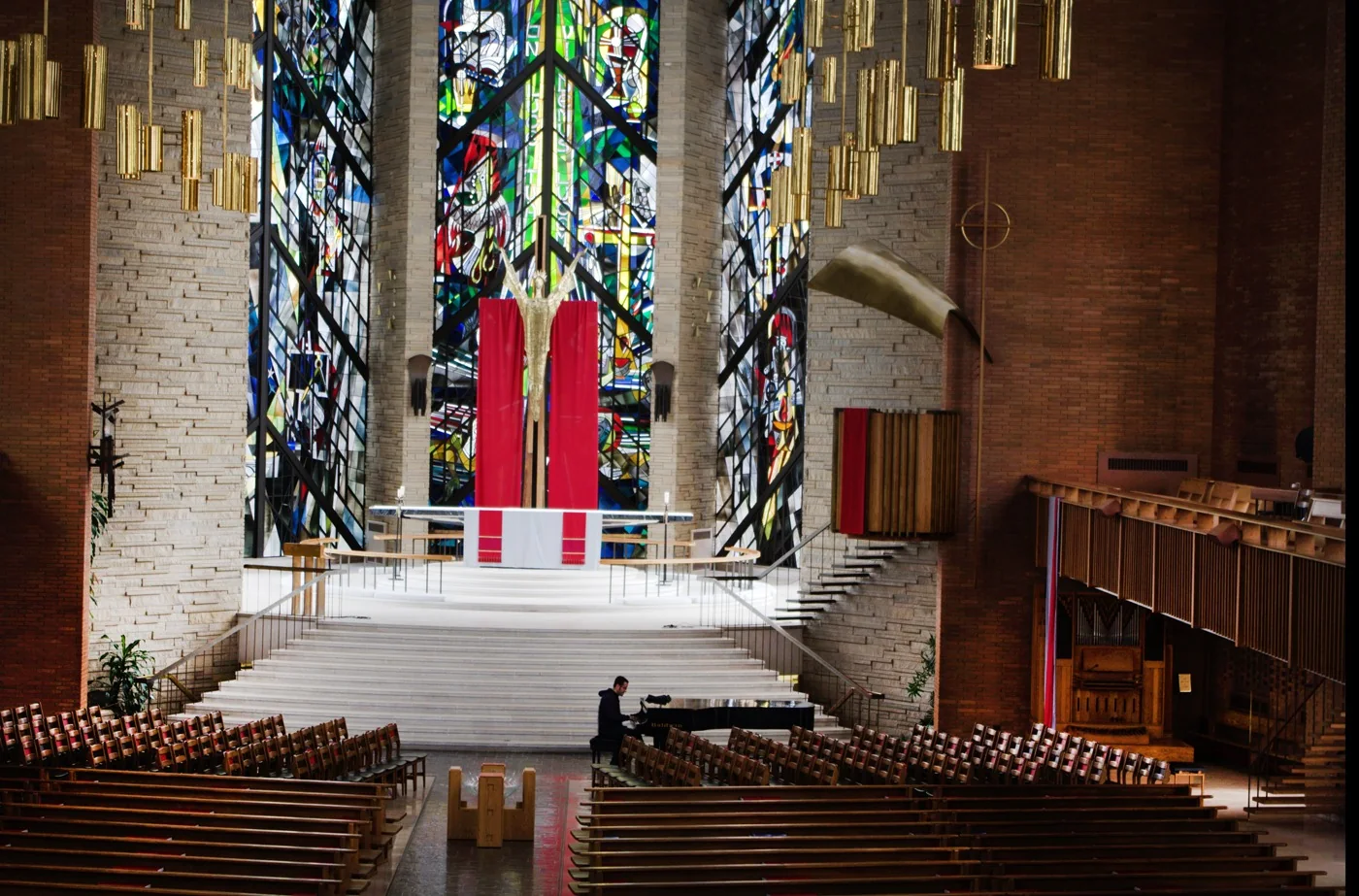 Gabriel Franco playing piano in a large sanctuary