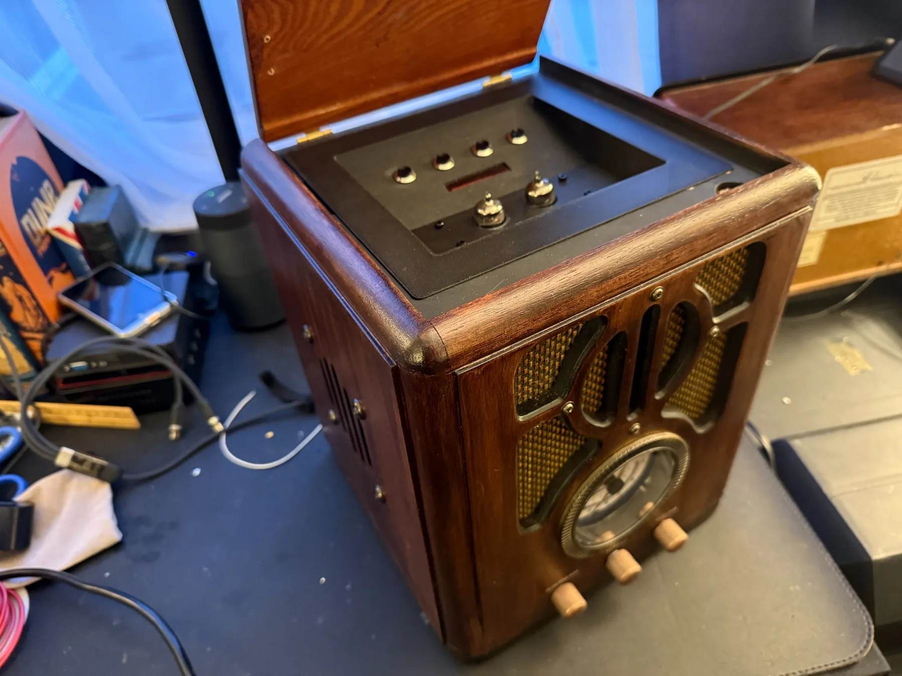 Vintage radio modernization project with the top open to show added controls