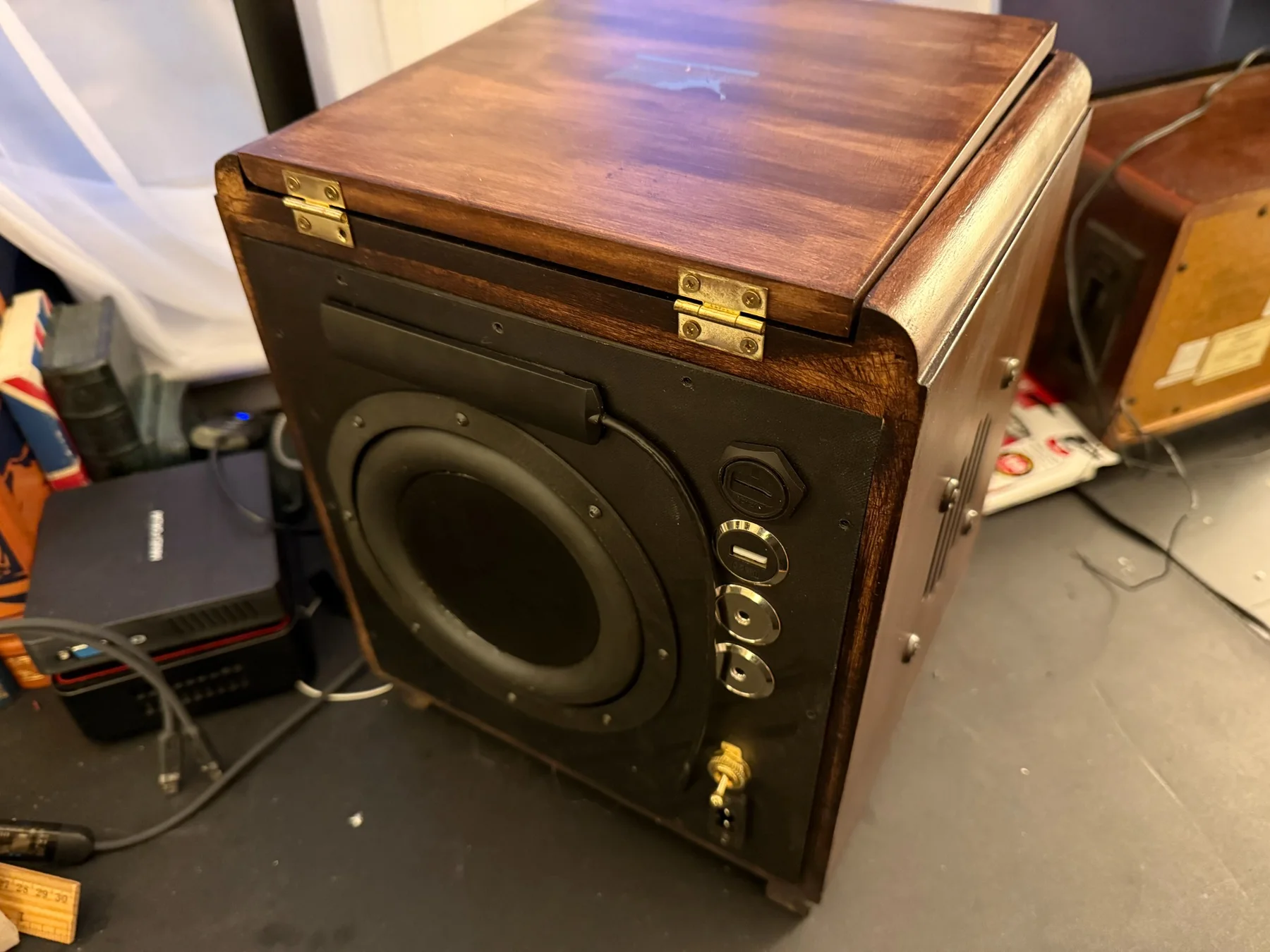 Rear of the vintage radio showing the fabricated passive subwoofer, ports, and upgraded hardware